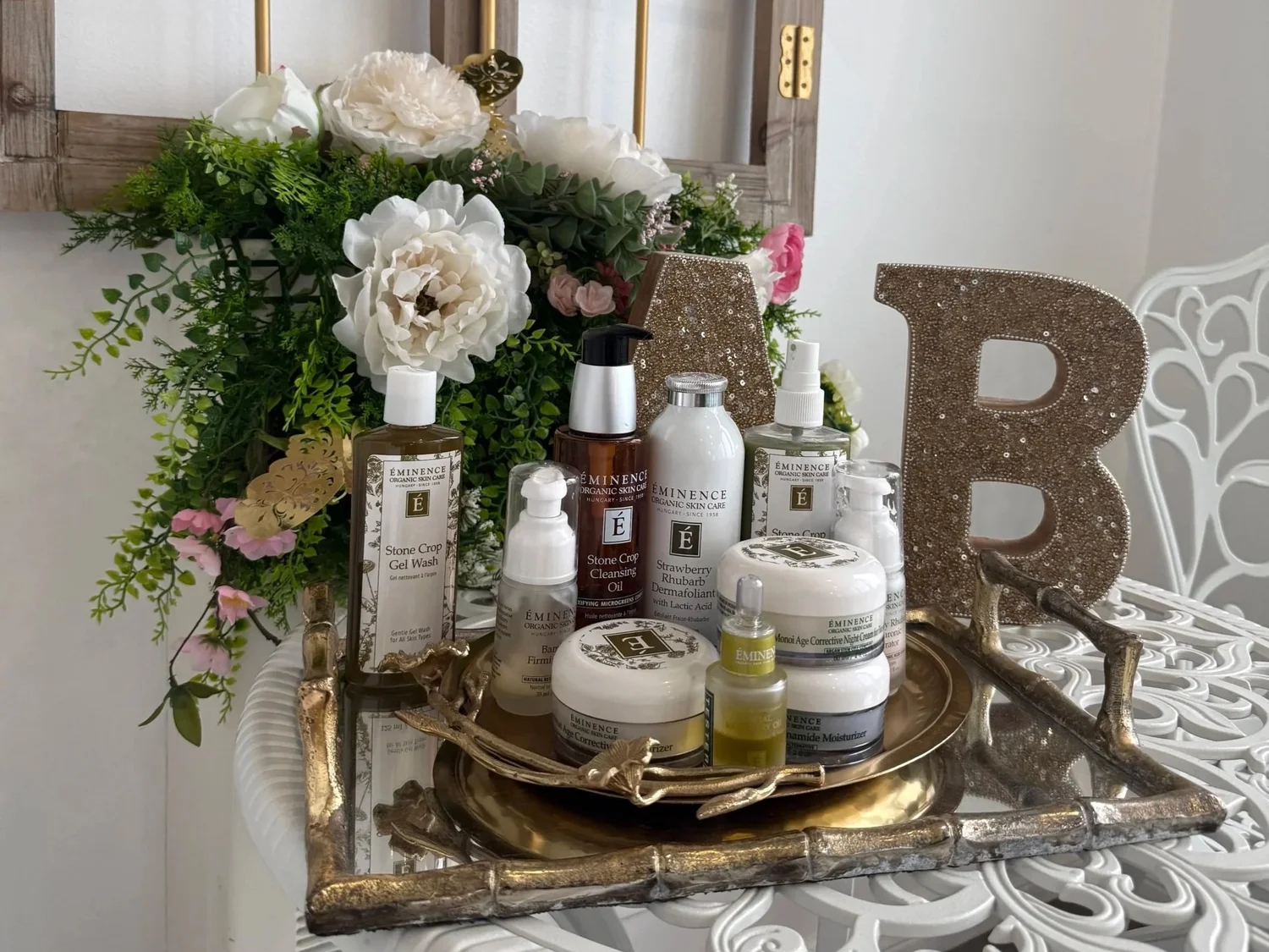 Skincare collection and flowers at Adore Beauté